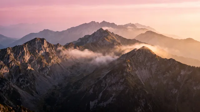 Misty alpine ridges at dawn